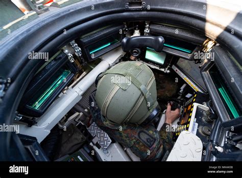 19 April 2018, Germany, Munster: A Bundeswehr commander sits inside a tank of the model Leopard ...