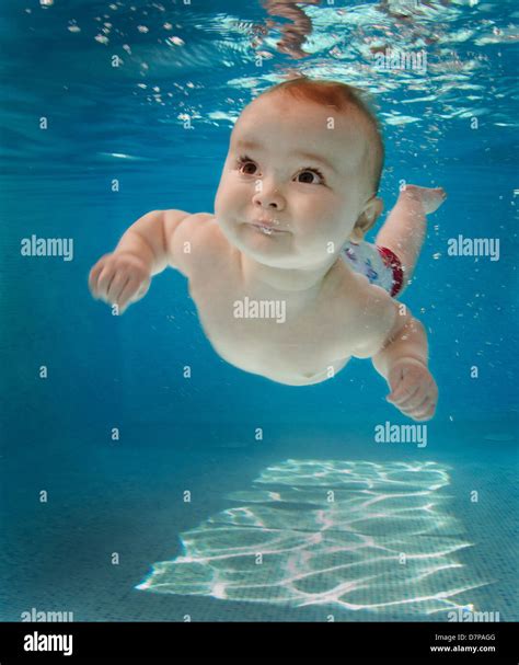 Baby Swimming Underwater in Swimming pool Stock Photo - Alamy