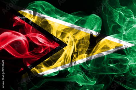 National flag of Guyana made from colored smoke isolated on black ...