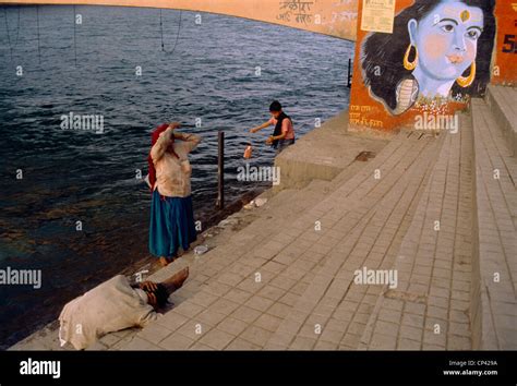 Hardwar India People Bathing In The Ganges Painting Of Lord Krishna On The Bridge Stock Photo ...