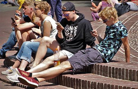 Royalty-Free photo: Two boy sitting on brown brick pavement taken during daytime | PickPik