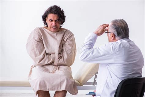 Aged Male Doctor Psychiatrist Examining Young Patient Stock Photo - Image of prisoner ...