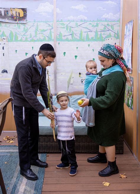 Parents helping son shake lulav and etrog 1 - The Jewish Life Photo Bank