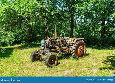 Old Broken Tractor in the Field Stock Photo - Image of parts, tree ...