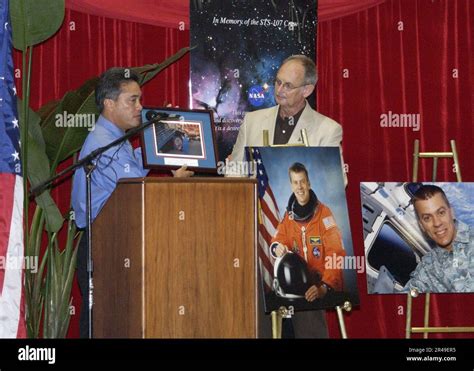 US Navy The Honorable Felix P. Camacho, Governor of Guam, presents a photo of U.S. Navy Cmdr ...