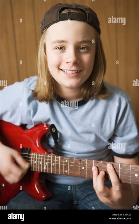 Caucasian boy playing electric guitar Stock Photo - Alamy