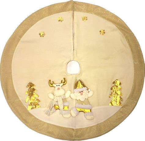 a white and gold christmas tree skirt with two stuffed animals