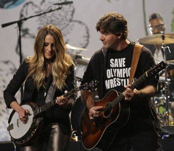 Musician Martin Strayer, here with wife, Emily Robison Srayer, shows support for Olympic ...