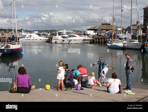 Families crab fishing at Padstow Harbour, Padstow, North Cornwall, England, U.K Stock Photo - Alamy