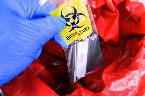 Premium Photo | Covid19 test in biohazard specimen bag is being thrown into the infectious waste bin