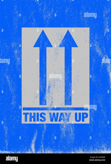 Scratched blue 'This way up' sign Stock Photo - Alamy