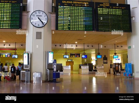 Check in desks and flight information board inside Malaga Airport ...