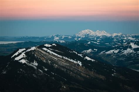 A view of a mountain with snow on it photo – Free Grey Image on Unsplash