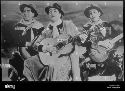 Carlos Gardel singing with two guitarists Stock Photo - Alamy