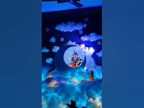 the ceiling is decorated with clouds, stars and an image of a man on a boat