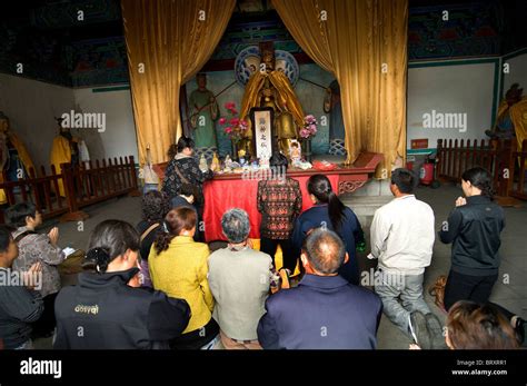 Prayers inside a Chinese temple Stock Photo - Alamy