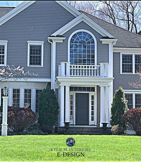 Exterior painted warm gray, Benjamin Moore Graystone, white trim, dark front door. Exterior ...