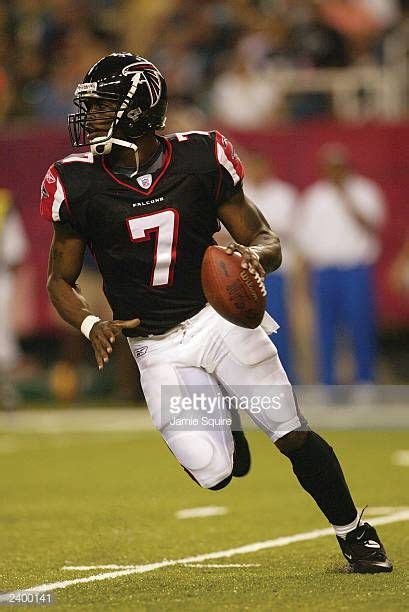 Quarterback Michael Vick of the Atlanta Falcons rolls out against the... | Michael vick, Atlanta ...