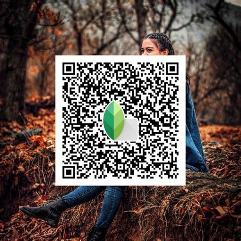 a woman sitting on top of a pile of leaves next to a qr code