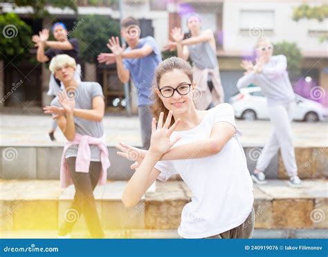 Teen Girl Dancing Modern Choreography with Group Outdoors Stock Photo ...