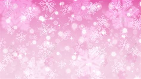 Christmas background with white blurred and clear snowflakes on pink background. Big fuzzy and ...