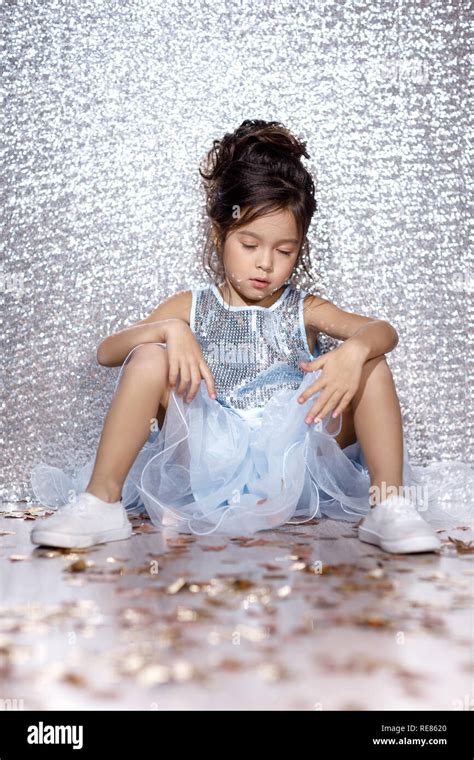 little child girl in dress sitting on the floor with confetti Stock Photo - Alamy