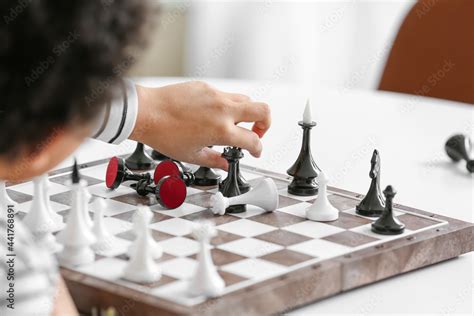 Cute African-American boy playing chess at home Stock Photo | Adobe Stock