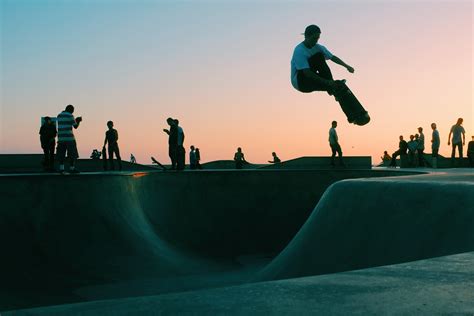 a man skateboarding at the skatepark at venice beach and boardwalk during sunset, venice beach ...