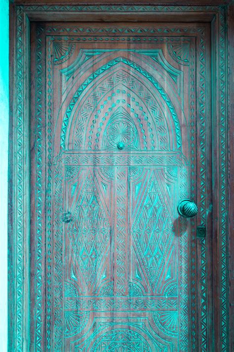 Download Craved Wooden Door In Moroccan Framework Wallpaper | Wallpapers.com