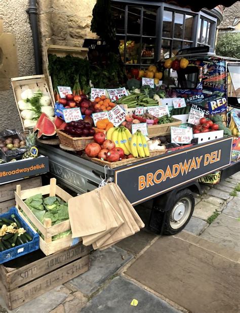 an outdoor market with fruits and vegetables on display