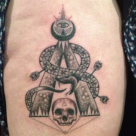 Medium size black ink detailed cilt style tattoo on thigh with snake and skull - Tattooimages.biz