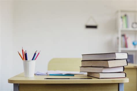 Premium Photo | Empty school desk with stationary and stack of book