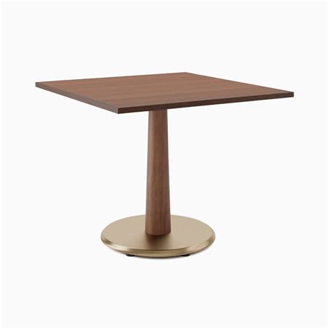 a square wooden table with a metal base on an isolated white background ...