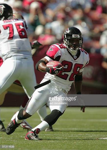 Running back Warrick Dunn of the Atlanta Falcons carries the ball... | Warrick dunn, Atlanta ...