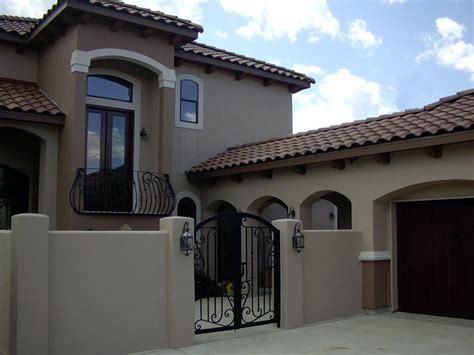 Courtyard, arch breezeway, iron gate, arch, tile roof, stucco wall, iron railing, balcony Stucco ...