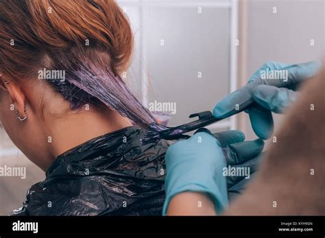 Professional hairdresser dyeing hair of her client in salon. Selective focus Stock Photo - Alamy