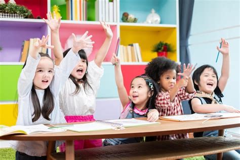 Premium Photo | Group diversity kids studying at school rising hands ...