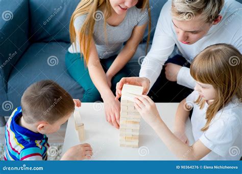 Family playing Jenga stock photo. Image of tower, happy - 90364276