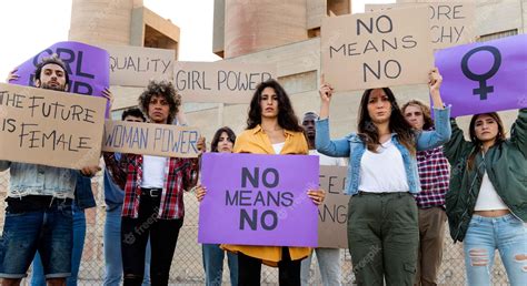 Premium Photo | Multiracial demonstrators looking at camera holding protest signs for women's ...