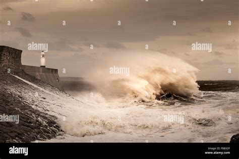 Storm Desmond hits Porthcawl and crash into the lighthouse and pier in South Wales, UK Stock ...