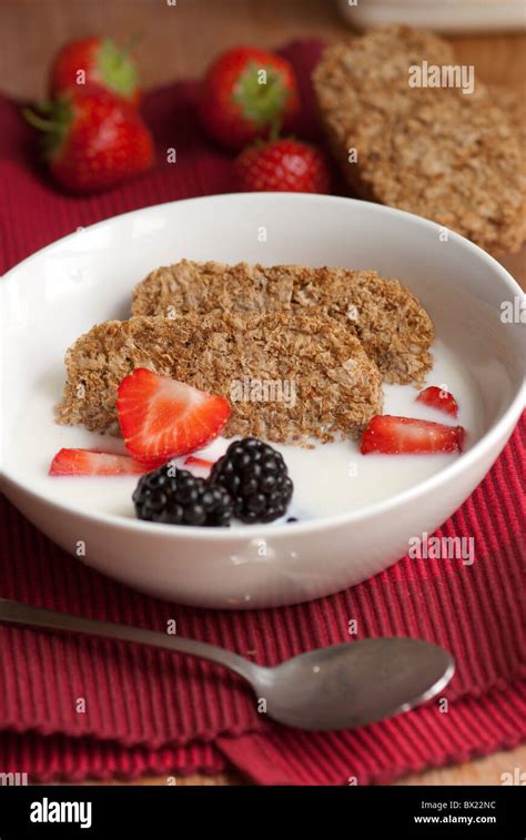 Wheat biscuits with berries and milk Stock Photo - Alamy