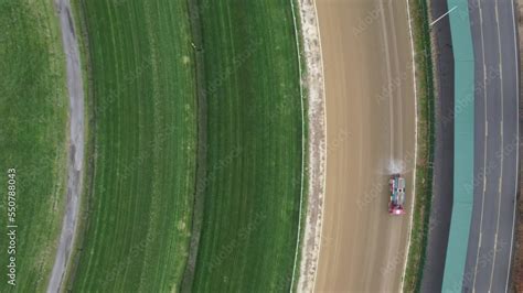 An aerial view of a horse race track on a cloudy day, while it was ...