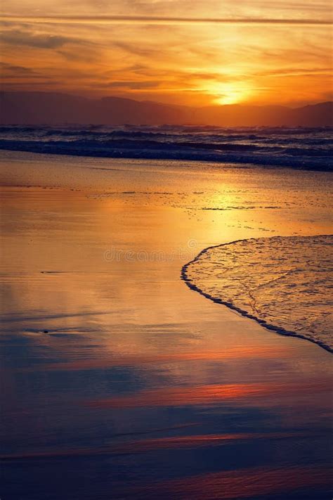 Beach shore at sunset stock photo. Image of light, waves - 61511620