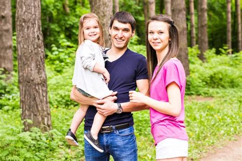 Portrait Of Happy Family In Garden - Stock Image - Everypixel