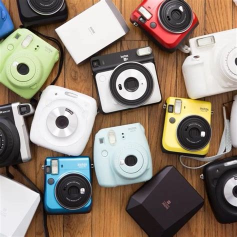 many different types of cameras on a table