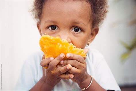 "Close Up Of Toddler Eating A Ripe Mango" by Stocksy Contributor "Anya ...