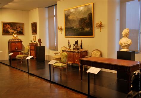 there are many pieces of art on display in this room, including chairs and desks