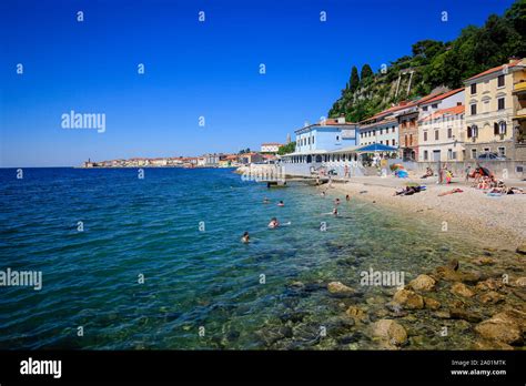 Piran, Istria, Slovenia - Beach life on the Fornace beach of the Mediterranean port of Piran ...