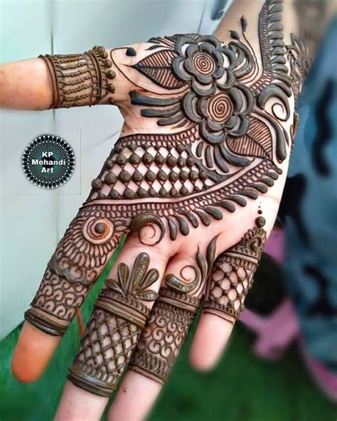 a woman's hand is decorated with hennap and intricate designs on it