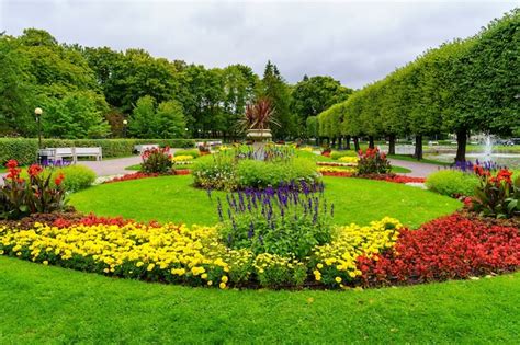 Premium Photo | Park with a multitude of colorful flowers and a small ...